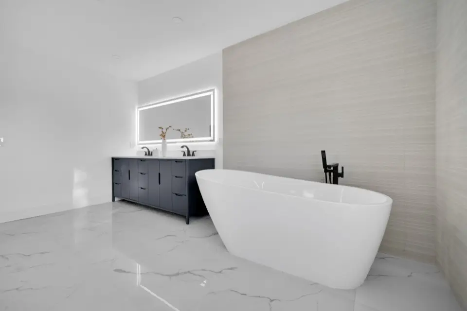 Primary bath with freestanding tub and marble-look floors